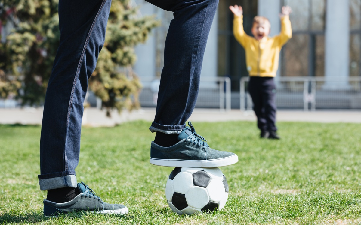 cropped-image-father-playing-football-with-his-son23